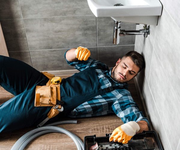 bearded handyman lying on floor near toolbox in ba resize