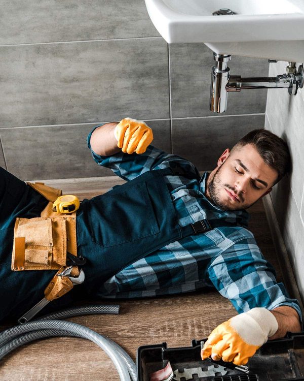 bearded handyman lying on floor near toolbox in ba resize